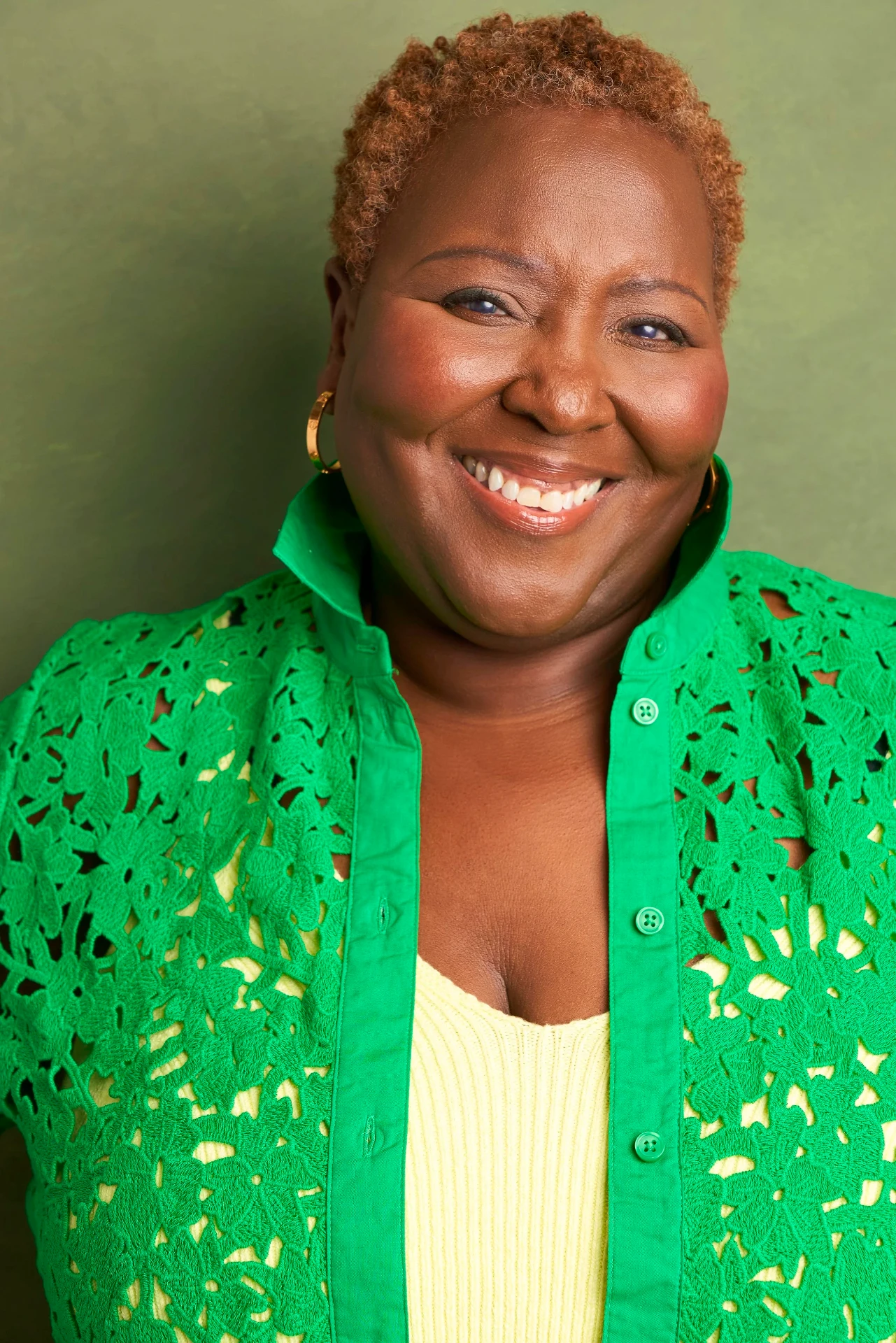 Joyful actress headshot in a green lace jacket by an Atlanta actor headshot photographer