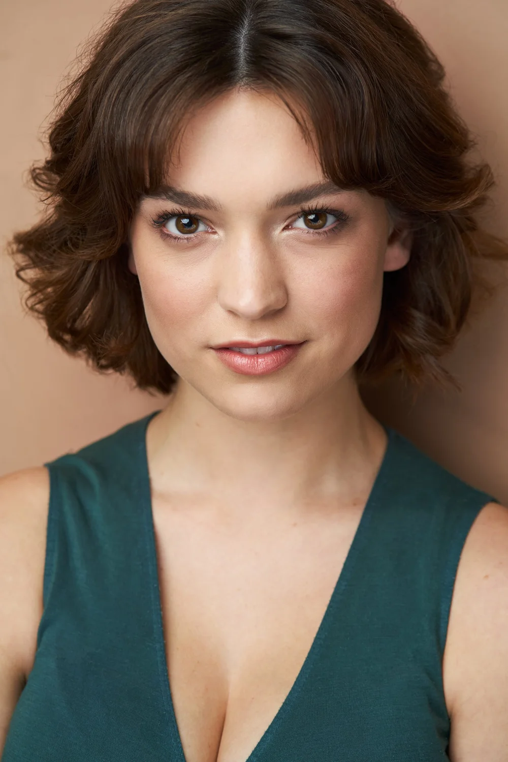 Theatrical actress headshot in a green top by Chase Anderson Photo in Atlanta