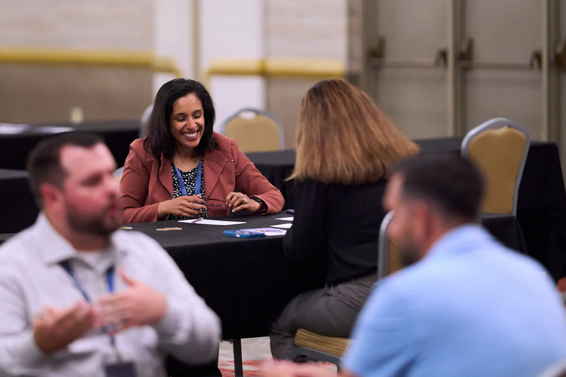 Laughing attendees at a conference roundtable
