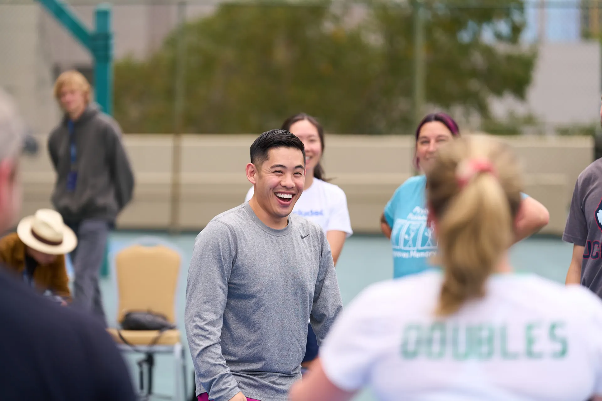 Laughing player on a conference pickleball court