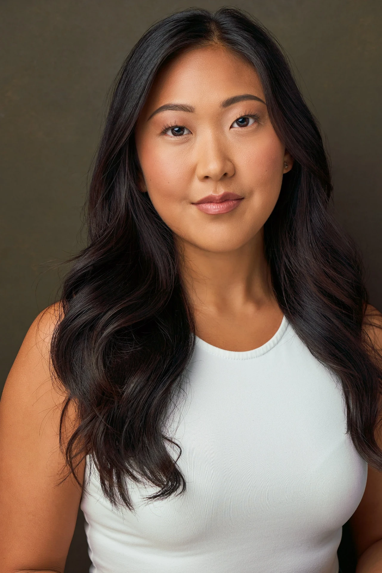 Editorial actor headshot of actress with long dark hair in a white tank, photographed by an Atlanta actor headshot photographer