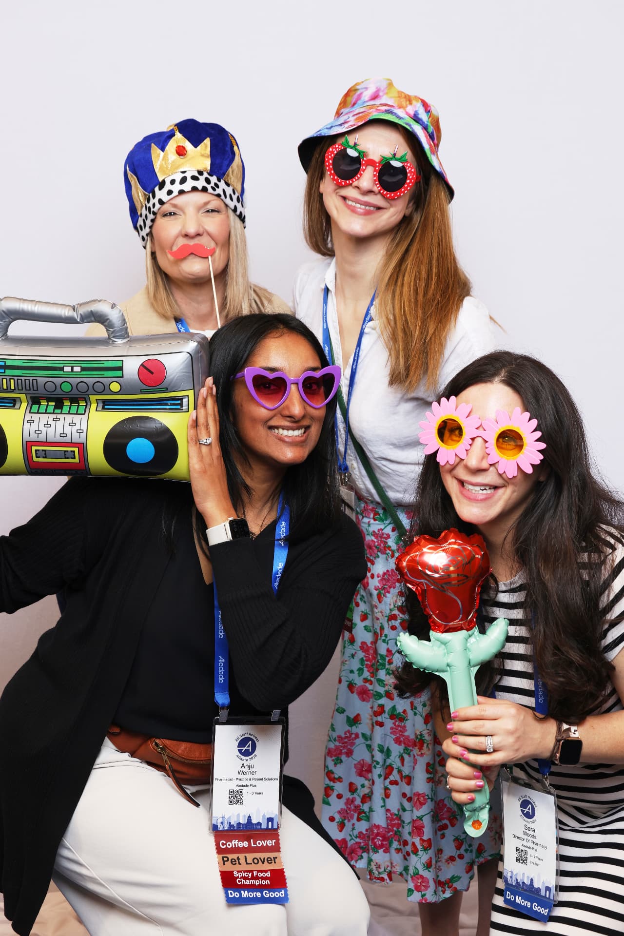 Four Aledade attendees with an inflatable boombox and rose, vertical photobooth frame at an Atlanta event