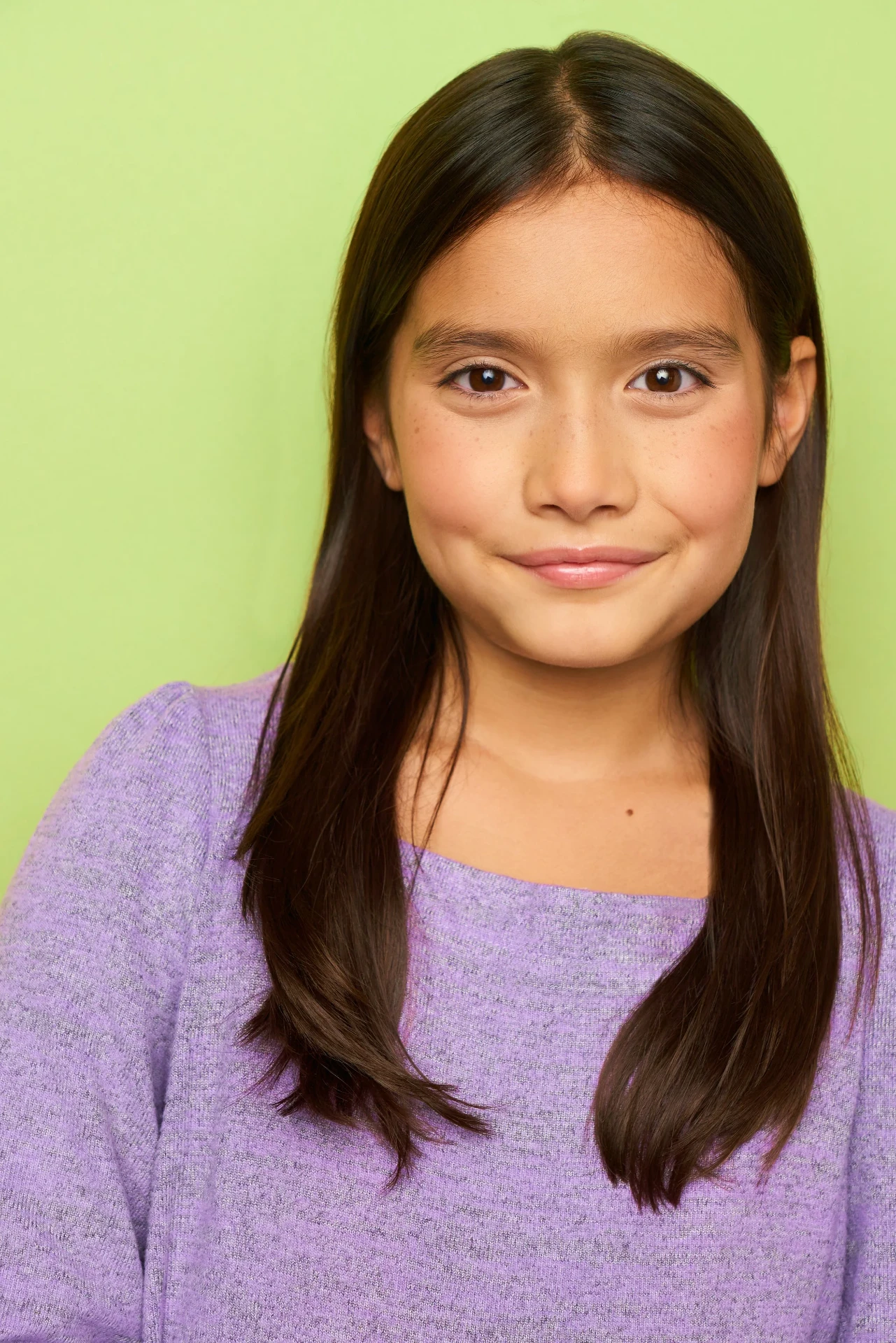 Editorial actor headshot of young actress in a lavender sweater on a lime backdrop, photographed by an Atlanta actor headshot photographer