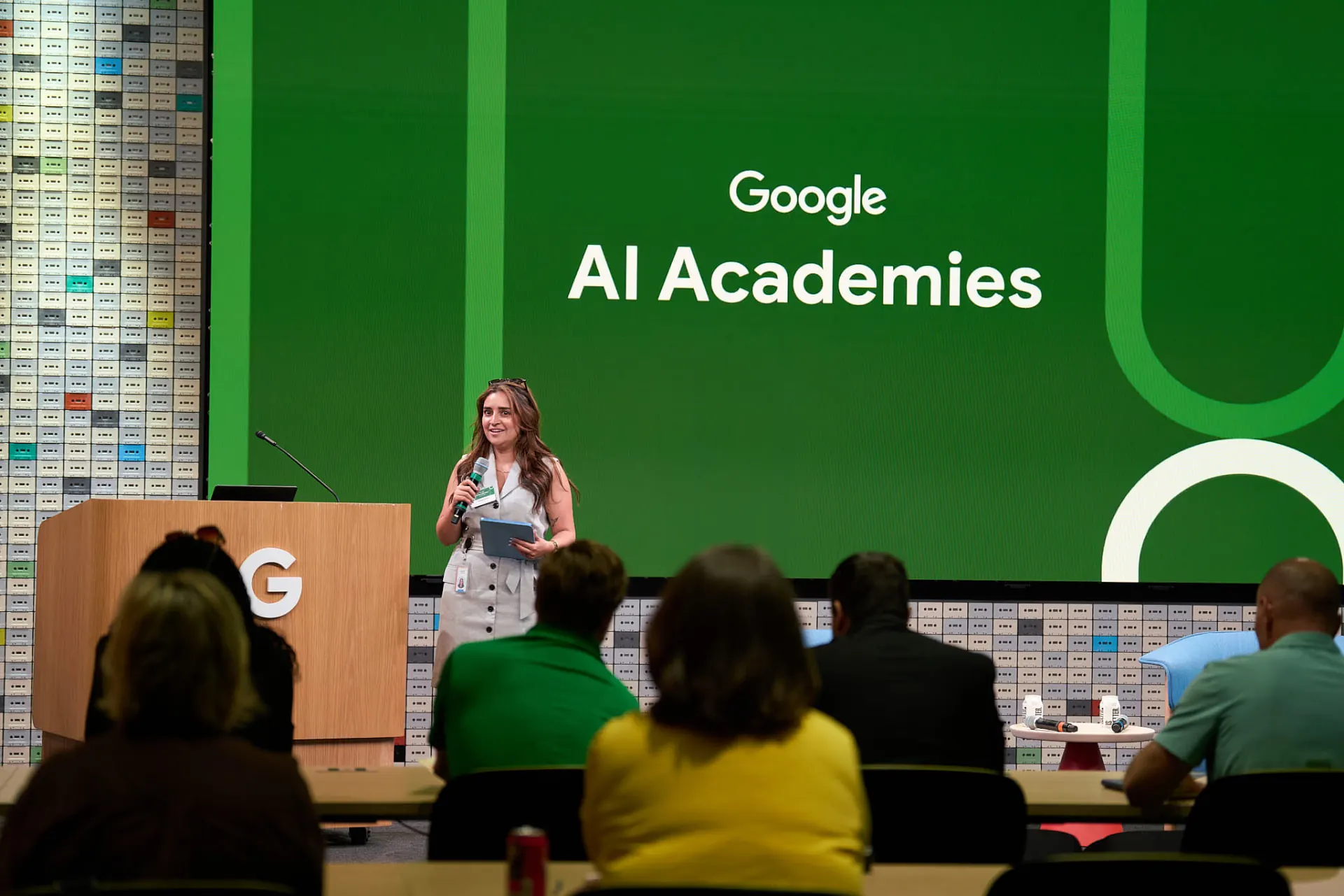 Speaker presenting in front of the Google AI Academies screen