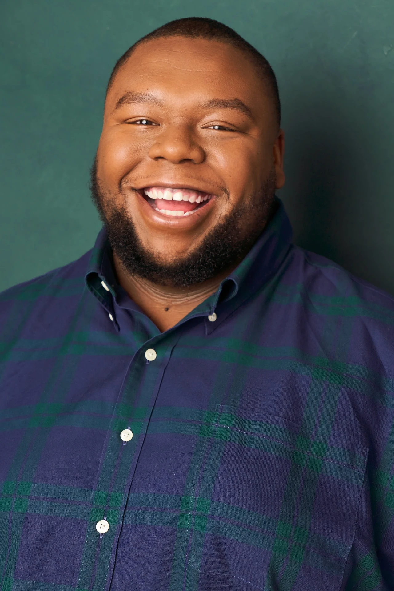 Editorial actor headshot of laughing actor in a plaid button-down, photographed by an Atlanta actor headshot photographer