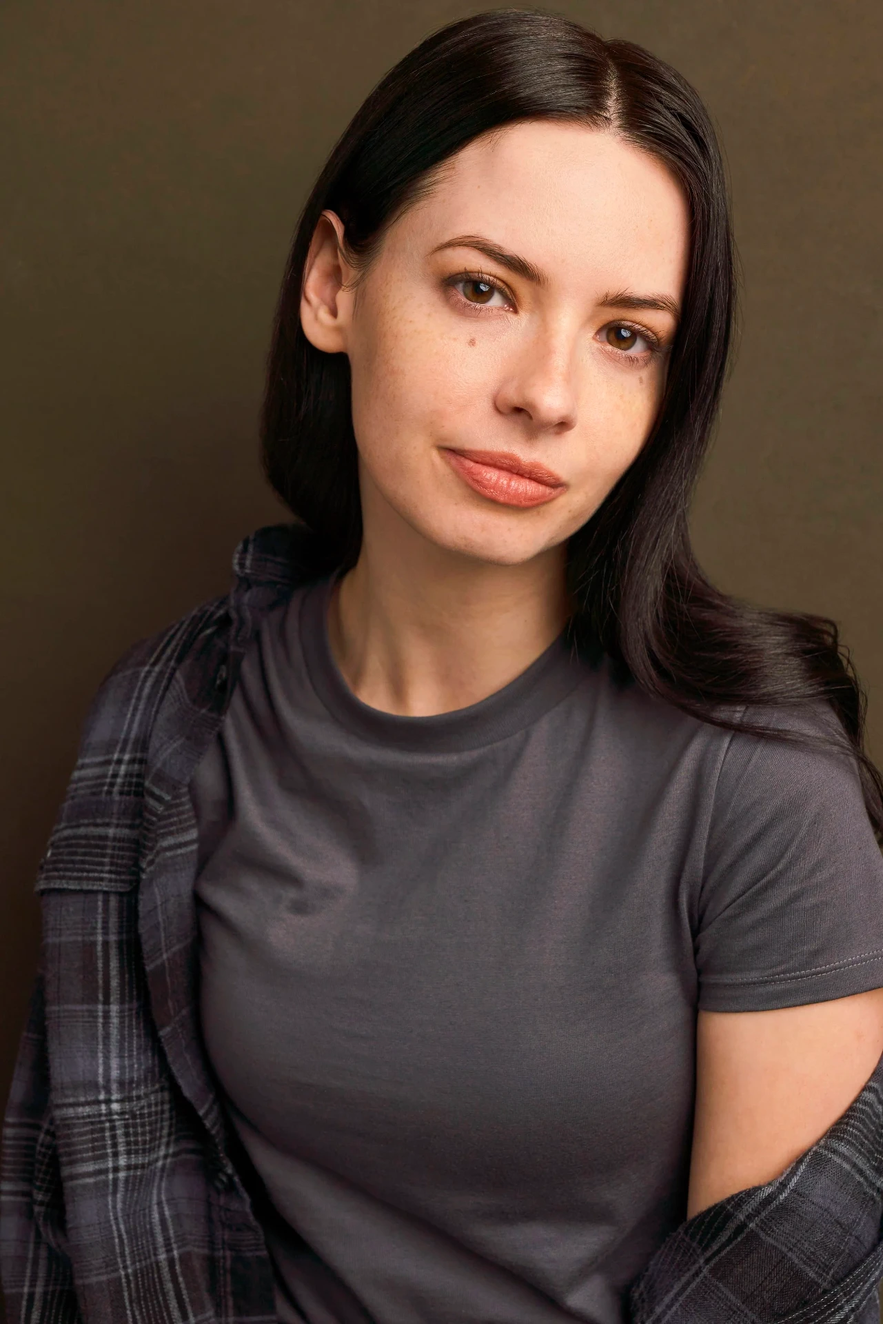 Editorial actor headshot of actress in a gray tee and plaid shirt, photographed by an Atlanta actor headshot photographer