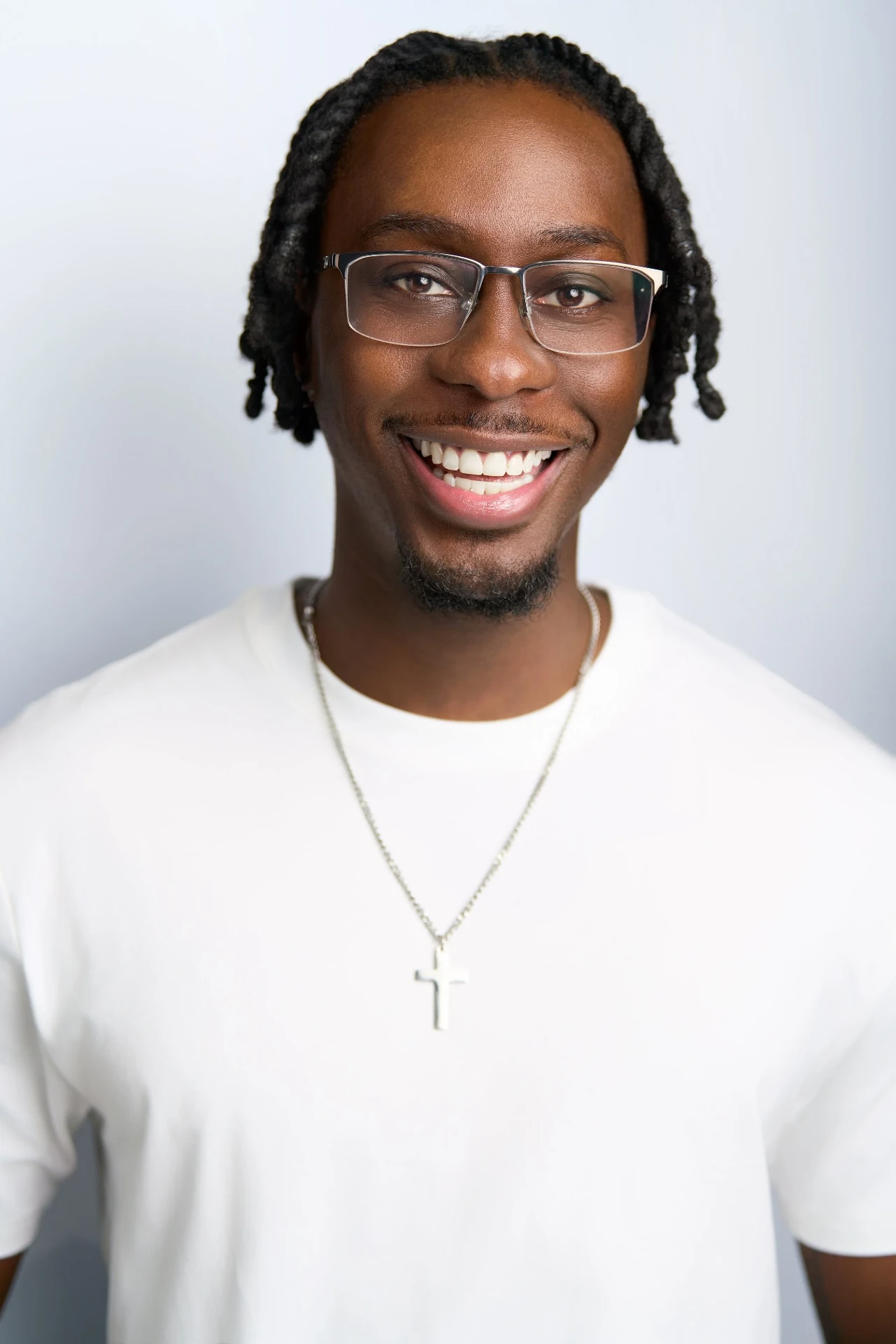 Smiling commercial actor headshot with glasses and a white tee in Atlanta