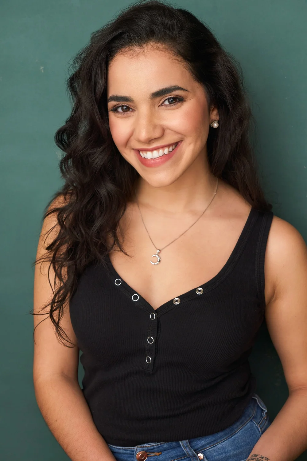 Smiling commercial actress headshot on a teal backdrop photographed in Atlanta