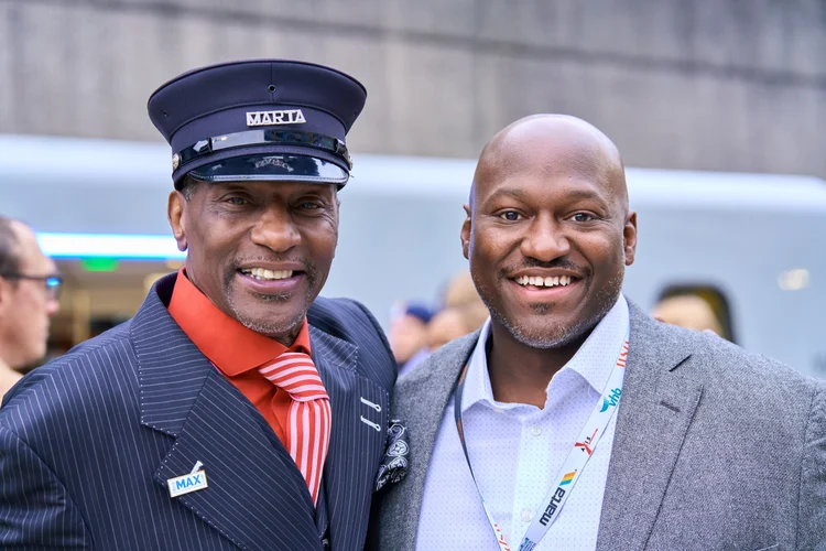 MARTA conductor with a smiling guest at an Atlanta event
