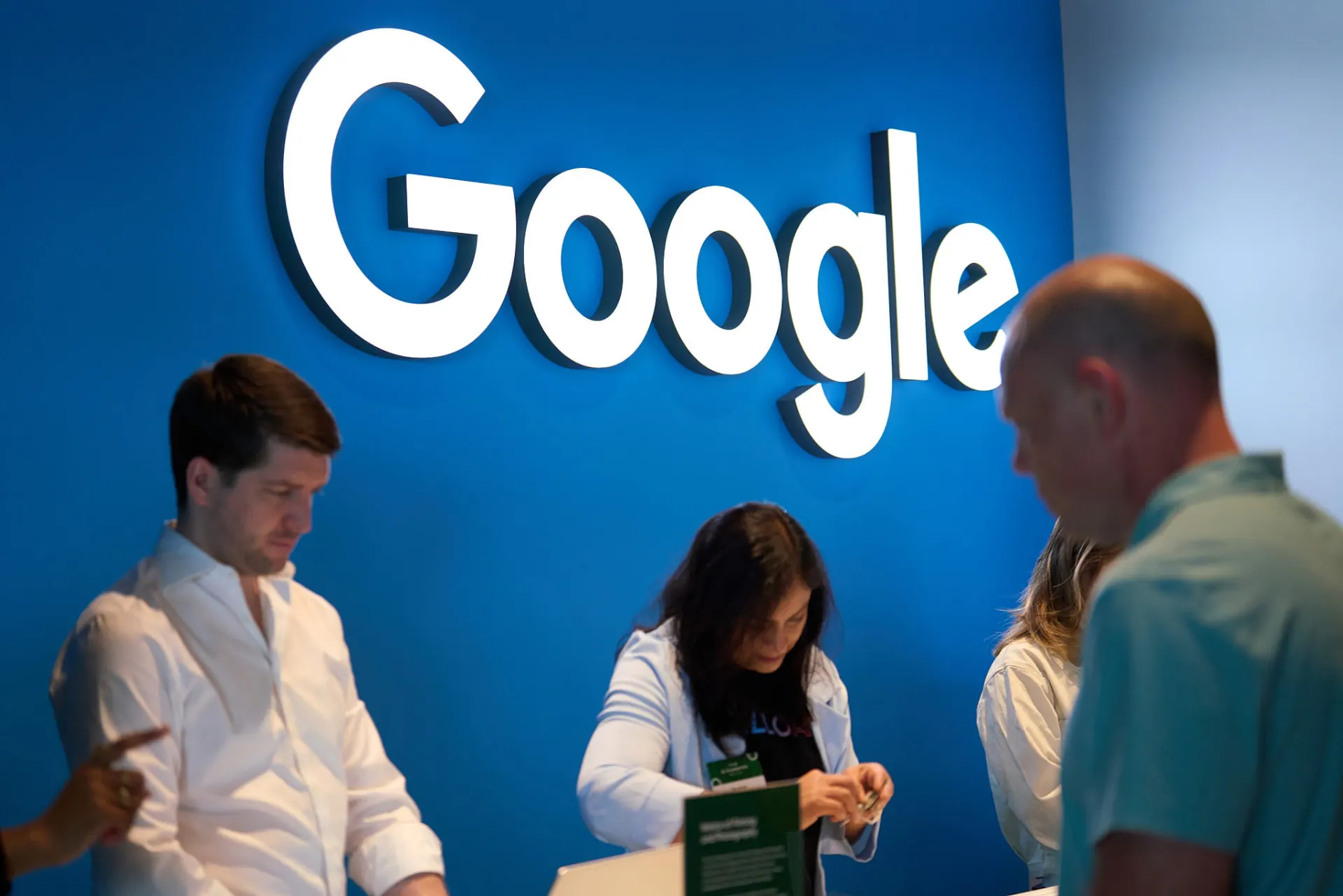 Attendees checking in under the Google welcome sign