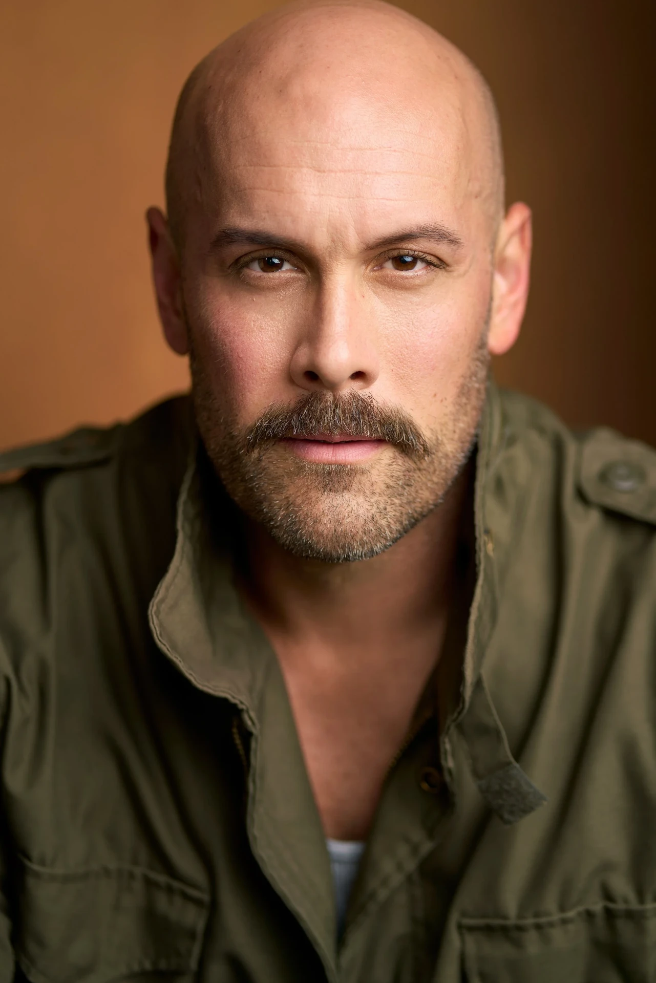 Rugged male actor headshot in an olive jacket photographed in Atlanta