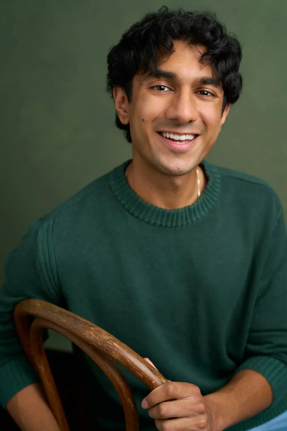 Approachable male actor headshot in a green sweater by Chase Anderson Photo in Atlanta