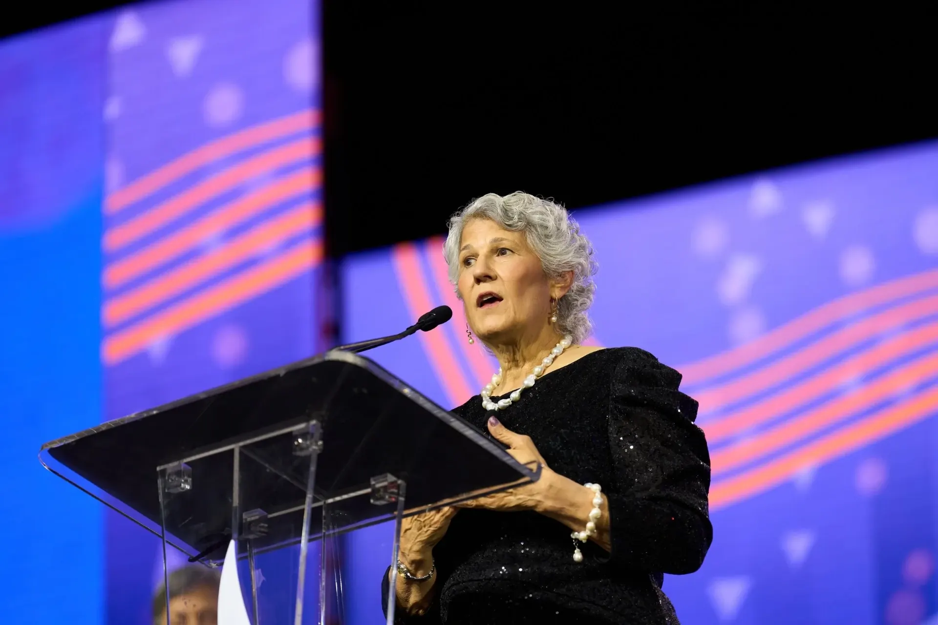 Keynote speaker presenting on stage to a full room at an Atlanta conference