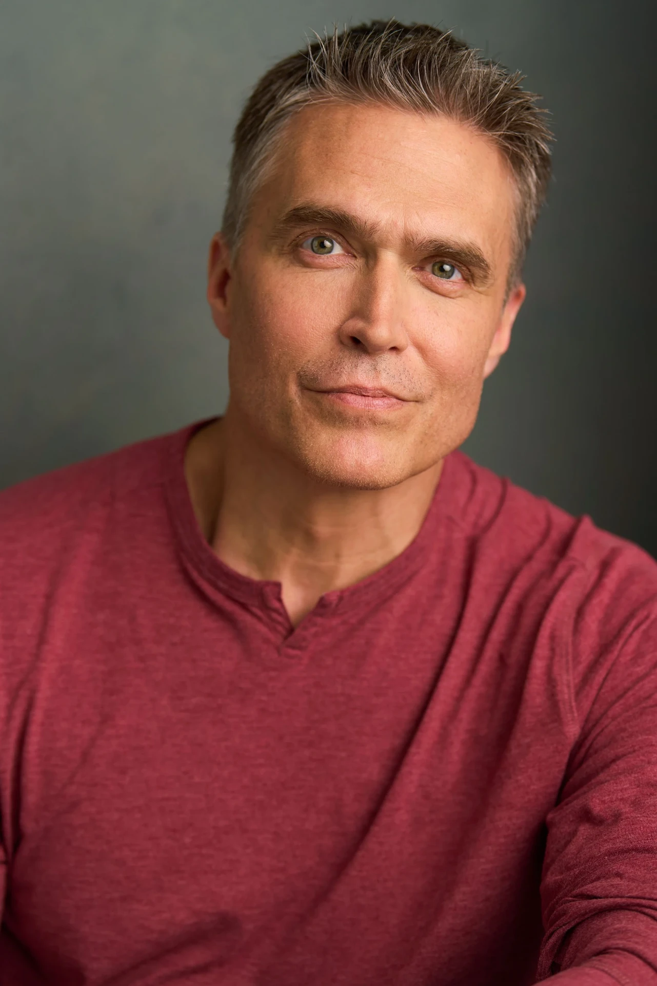 Editorial actor headshot of actor in a red henley on a gray backdrop, photographed by an Atlanta actor headshot photographer