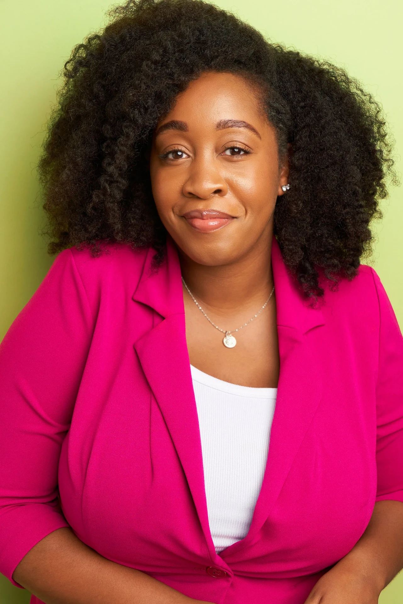 Actress headshot in a magenta blazer on a lime backdrop in Atlanta